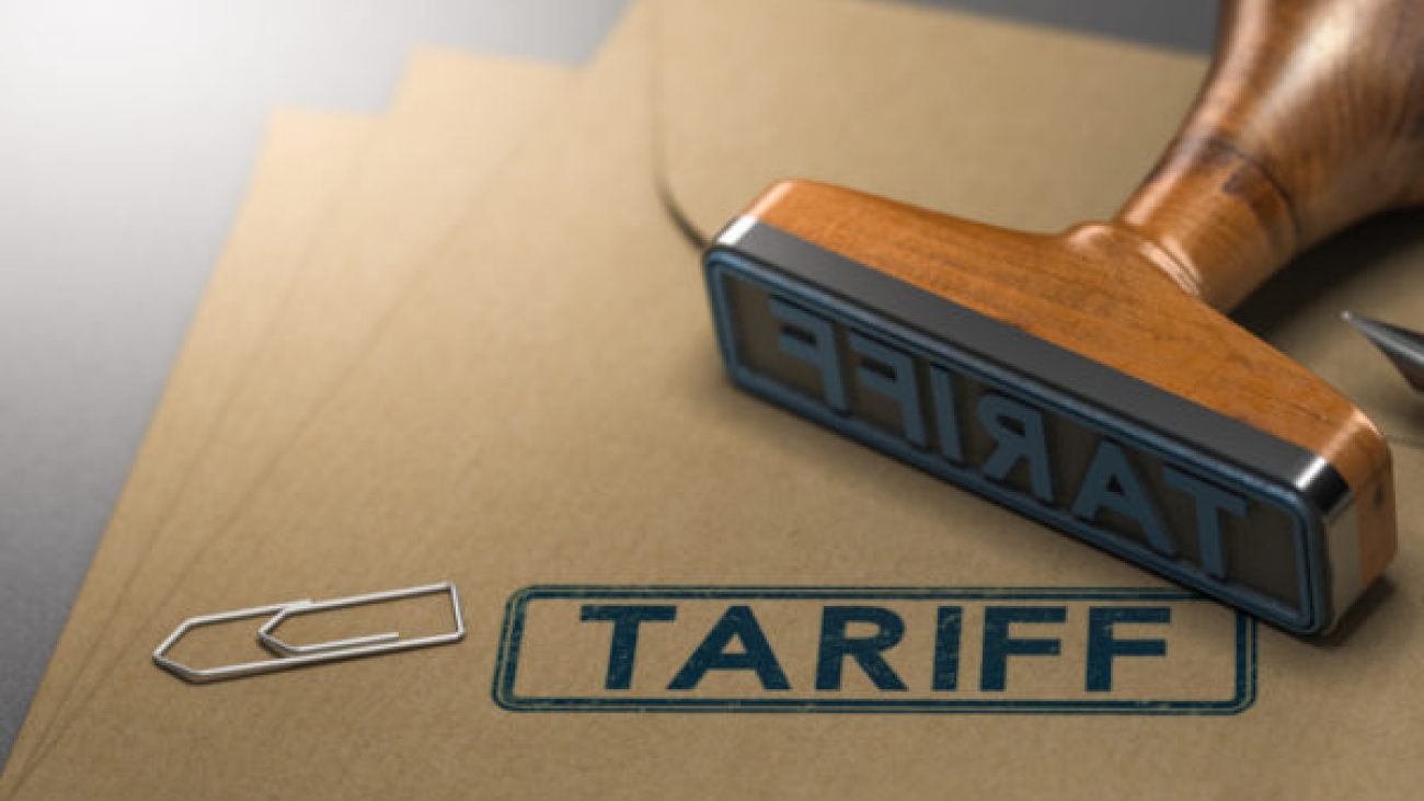3D illustration of a rubber stamp with the word tariff stamped on paper background. Concept of taxes or duties on imported goods.